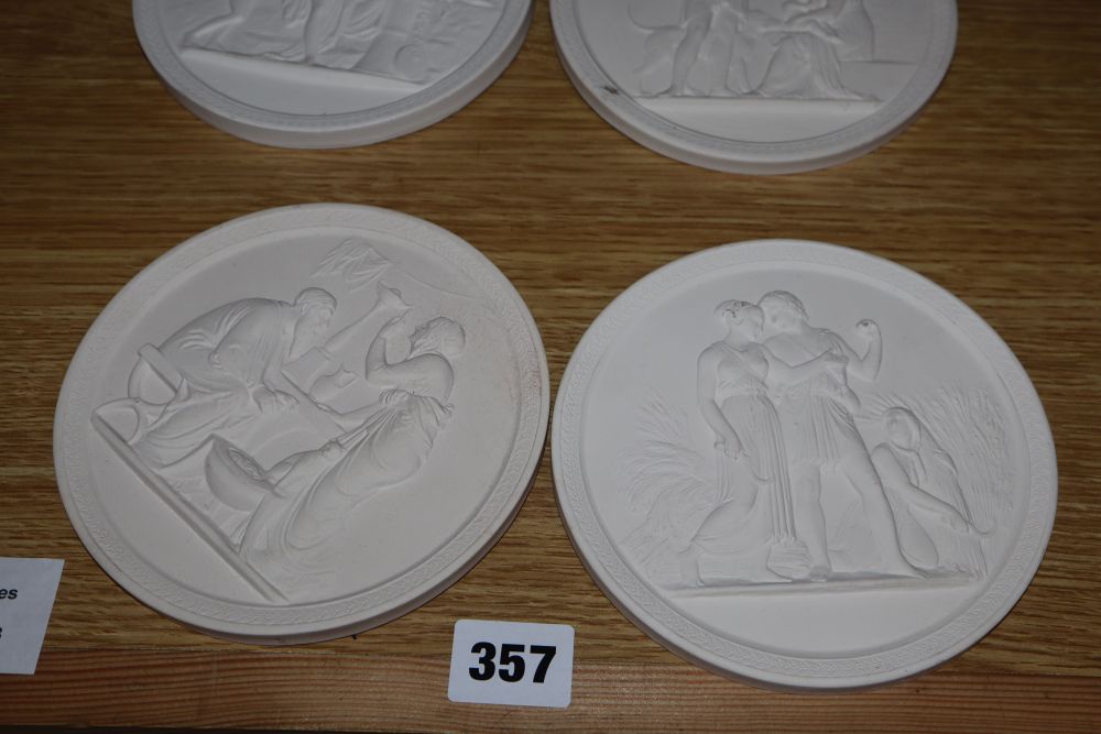 A set of four classical plaster wall plaques, diameter 13.5cm